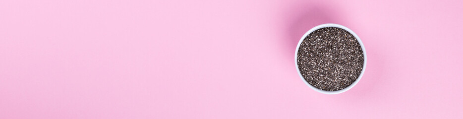 Seeds of Chia on the pink  background.Trendy Bright Colors. Concept. Minimalism. Healthy Food. Diet Nutrition. Top View. Flat Lay. Copy space for Text. Banner