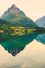 Reflection of mountains in norwegian fjord lake