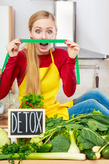 Woman having green diet vegetables, detox sign