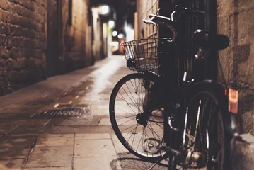 Poster Retro-Fahrrad in der nächtlichen Altstadt auf Hintergrund Bokeh-Licht-Flare in der Nachtarchitektur, Vintage-Fahrrad in der Abendstraße in Barcelona-Stadt, Fahrradtransport in Defokus-Kulisse, Reisekonzept © A_B_C