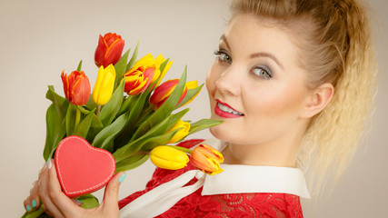 Woman holding tulips and gift