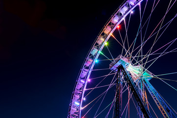Big ferris wheel with festive colorful illumination