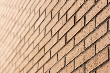 brown brick wall in perspective and out of focus in the background
