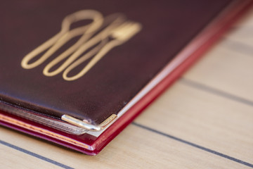 menu letter of a restaurant on a table with lines