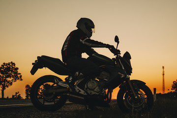 Fototapeta na wymiar Dark figure of rider on motorcycle