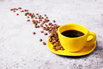 Coffee Beans Fragrant in the Yellow Cup on the Gray Background. Copy space for Text.