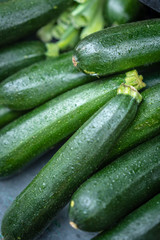 Fresh green organic courgettes on sale