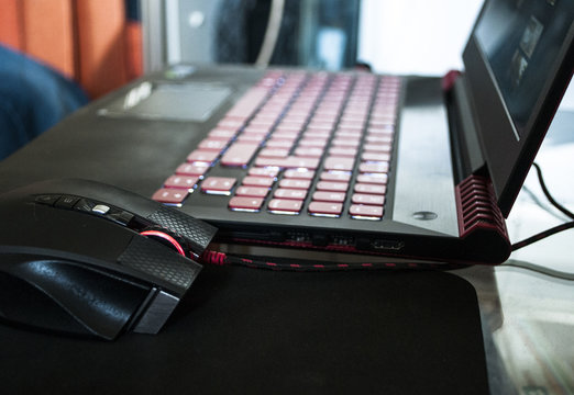 A red-black gaming laptop with a luminous keyboard