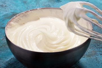 close up of a white whipped or sour cream in bowl.