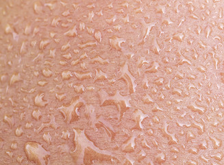  background of  human skin texture covered with large drops of fresh shiny water