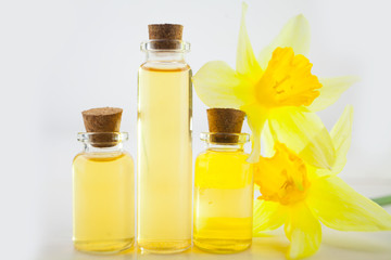 Essence of flowers  on white in beautiful glass jar