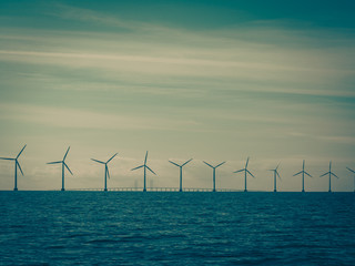 Wind turbines power generator farm along coast sea