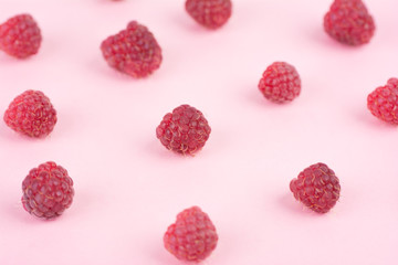 Raspberry isolated on pink background. Close up, pattern.
