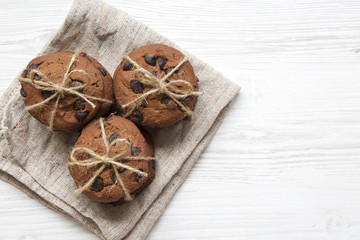 Chocolate chip cookies on a white wooden surface, top view. Closeup. Copy space.