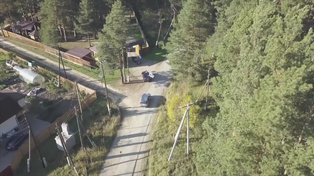 Aerial View. Video. Aerial view of cars driving on a road in the village. Russia. Summer