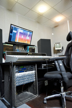 From below view of working console with monitors and musical electronics in sound studio.