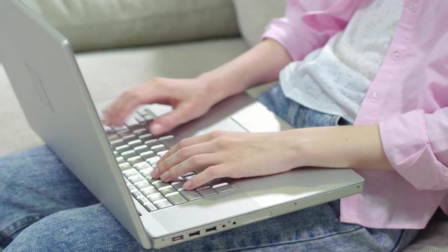 Close up view of womans hand keyboarding on laptop, Girl quickly typing on computer.