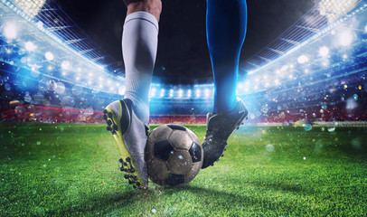 Soccer players with soccerball at the stadium during the match