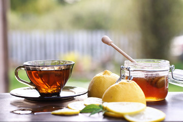 Fresh honey with a cup of black tea