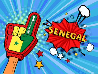 Fototapeta premium Male hand in the country flag glove of a sports fan raised up celebrating win and Senegal speech bubble with stars and clouds. Colorful illustration in retro comic style