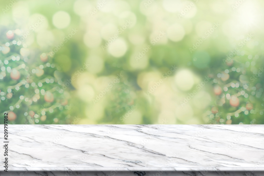 Aufkleber Empty white marble table top with abstract blur christmas tree background with bokeh light,Holiday backdrop,Mock up banner for display or montage of product.