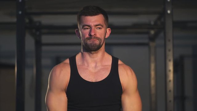 sporty muscular man are working out in gym