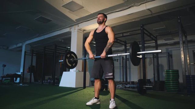athlete doing exercise with a barbell