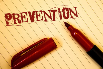 Text sign showing Prevention. Conceptual photos Stopping something from happening Healthcare ProtectionIdeas messages created on notebook page black red letters open pen resting.