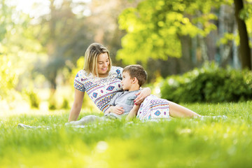 Mother and son on blanket in park outdoors