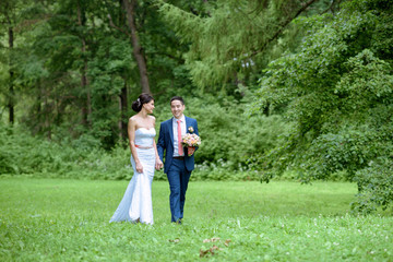 Naklejka na ściany i meble Wedding couple on the nature is walking