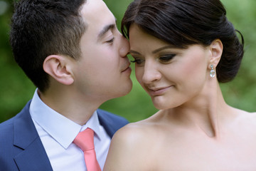 Wedding couple on the nature is hugging each other