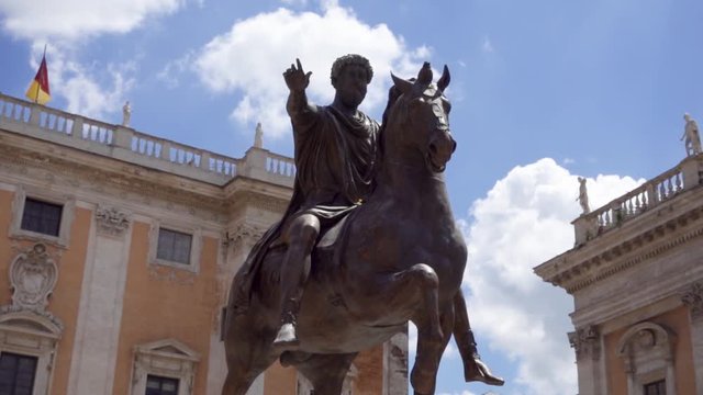 Bronze statue of Emperor Marcus Aurelius on horse on Capitol Hill in Rome, Italy in slow motion. Piazza del Campidoglio in summer day