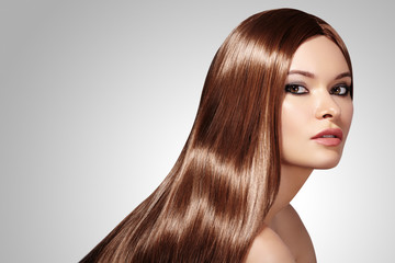 Beautiful yong Woman with Long Straight Brown Hair. Sexy Fashion Model with Smooth gloss Hairstyle....