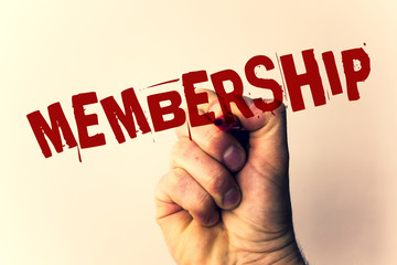 Handwriting text writing Membership. Concept meaning Being member Part of a group or team Join an organizationMan holding pen pointing idea message black red letters beige background.