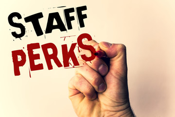 Handwriting text writing Staff Perks. Concept meaning Workers Benefits Bonuses Compensation Rewards Health InsuranceMan holding pen pointing idea message black red letters beige background.
