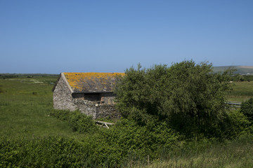 Old stone barn with orange roof unny landscape and rural views braunton, devon, north, british, united, kingdom