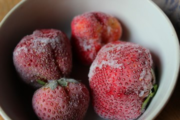 Frozen strawberries on a plate.