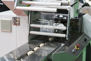 Automatic packing machine with plastic bag and paper box