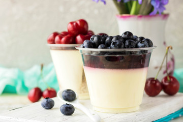 Italian dessert pana cota with berry jam and fresh blueberries