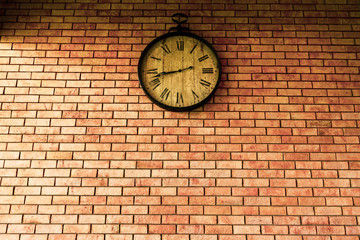 Wall Clock vintage retro styles hanging on the brick wall.