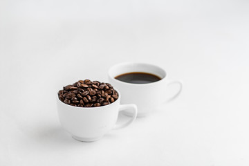 Coffee and coffee beans in white cups, white background