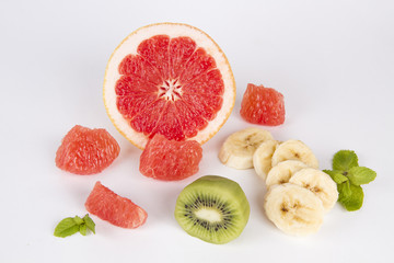 grapefruit slice, banana and kiwi fruit on white background