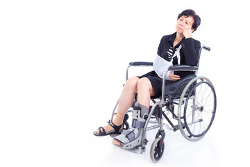 Fototapeta na wymiar Asian businesswoman with broken arm and leg sitting on wheel chair over white background