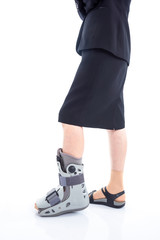 Woman leg with brace standing over white background