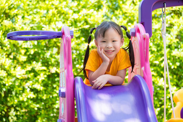 Fototapeta na wymiar Little asian girl playing at school playground