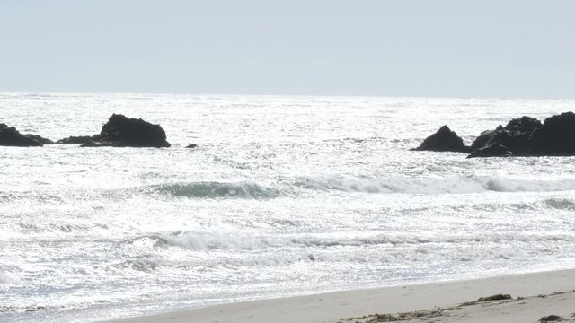 Waves splashing against rocks at sea in California
