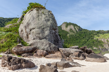 Big rock at white sandy beach