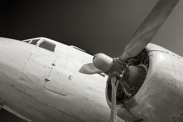 Close up on old airplane (biplane) with enormous propeller engine and cockpit