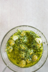 Homemade Spanish Style Pitted Green Olives Marinated in Oil with Garlic Herbs and Parsley. Top View. Mediterranean Cuisine. Healthy Diet Appetizers Tapas Hors d'oeuvres. Recipe Template Copy Space