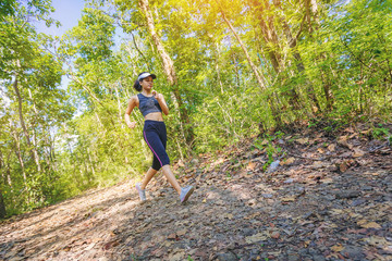 Young woman runner athlete running on forest trail. motion movement